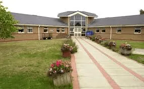 Two people have been arrested after a suspicious package containing suspected drugs and mobile phones was thrown into Erlestoke prison gr…