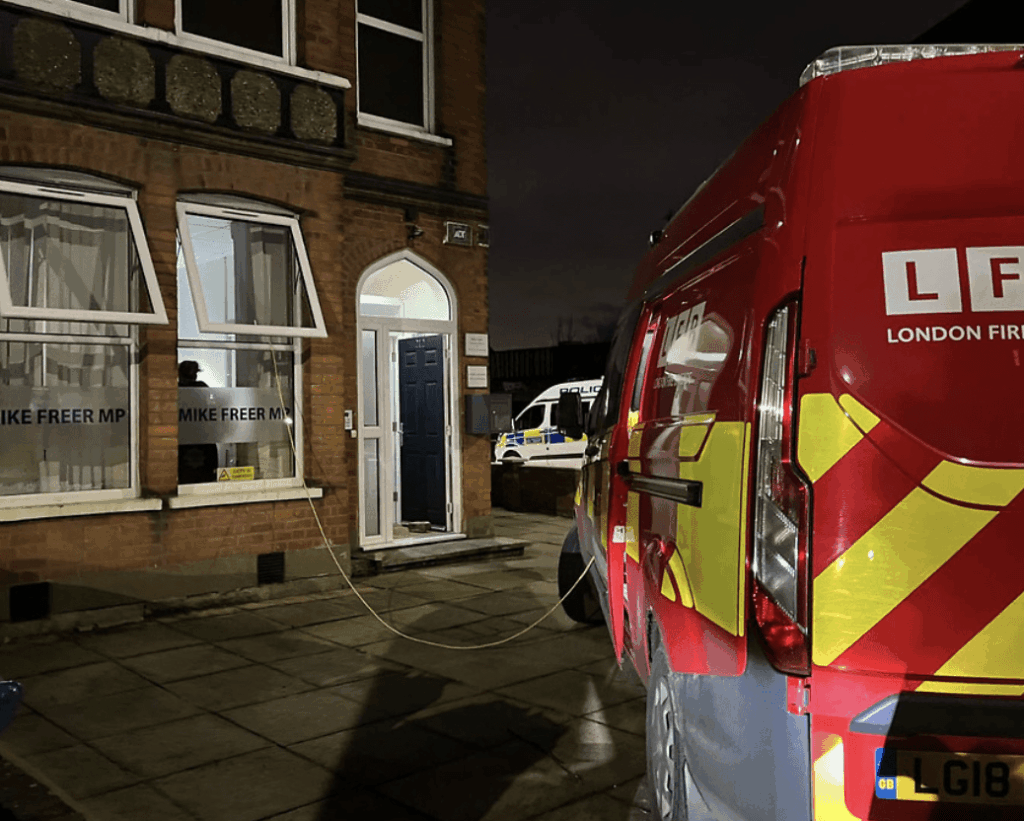 Two people have been charged in connection with a fire in a shed at the constituency office of MP Mike Freer in North Finchley