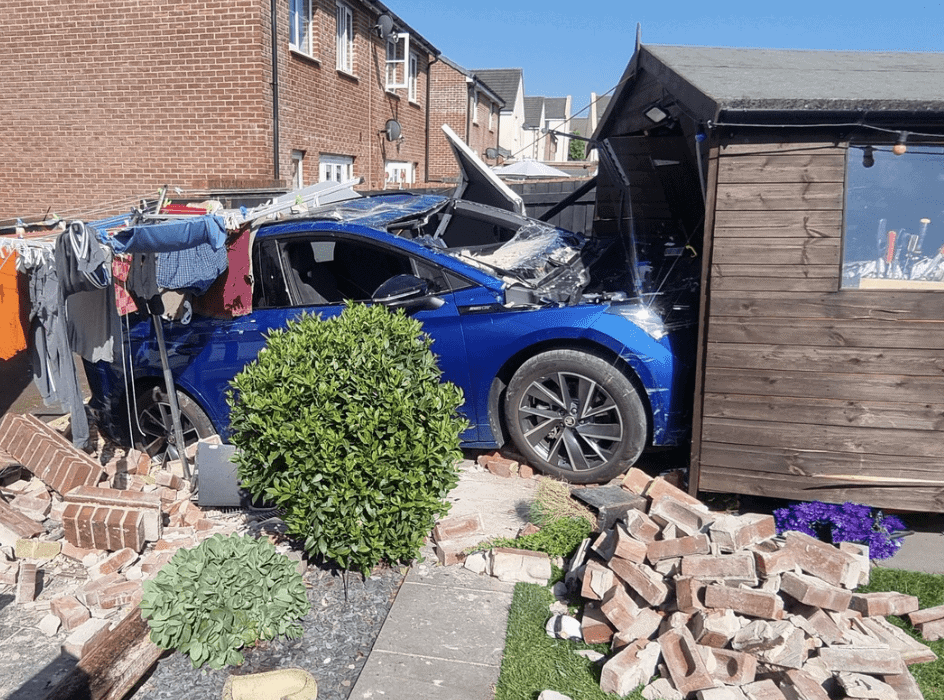 Electric Car Crashes Into Shed in Newton Abbot Garden — Fire Crews Make Scene Safe