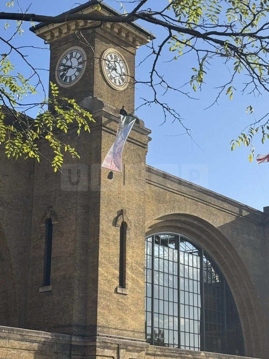 Protester and Pet Dog Scale Kingâ€™s Cross Clock Tower in Anti-Iranian Government Demonstration