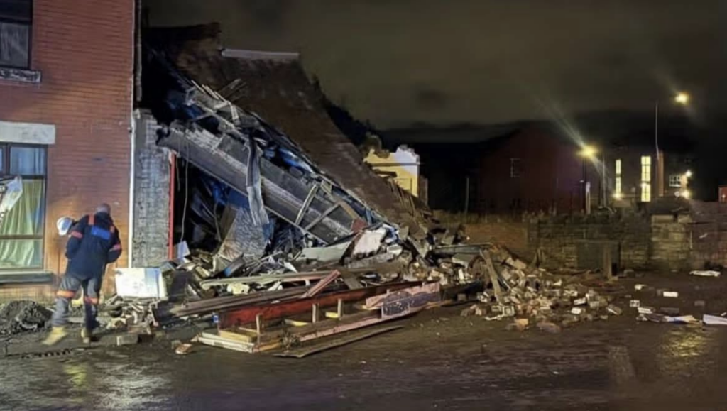 Building collapses after vehicle crashes into shop in Bolton as emergency services rush to scene