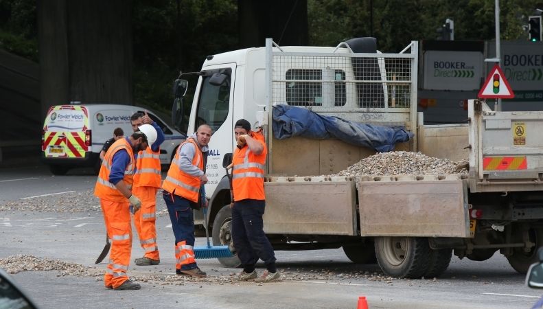 Police Called To Shovel Shingle After Flatbed Truck Sheds Load
